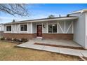 Attractive home showcasing light blue siding, brick accents, and a well-manicured lawn with trees at 12550 Maria Cir, Broomfield, CO 80020