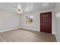 Spacious open-concept living area with wood floors, natural light, and a front door at 12550 Maria Cir, Broomfield, CO 80020