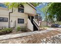 Exterior view of the condo featuring a front entrance with stairs, balcony, and landscaping at 4903 W 73Rd Ave, Westminster, CO 80030