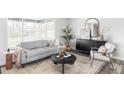 Cozy living room featuring stylish furniture, a decorative mirror, and ample natural light at 1561 W Beekman Pl, Denver, CO 80221