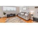 Well-lit living room with a comfortable sofa, modern decor, and hardwood floors, perfect for relaxation at 1151 N Marion St # 104, Denver, CO 80218