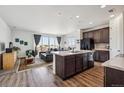 Open-concept living room and kitchen filled with natural light from large windows at 95 S Edge Cliff St, Castle Rock, CO 80104