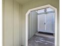 View of the gated front entryway with painted siding and concrete step at 3283 W 102Nd Pl, Westminster, CO 80031