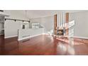 Bright living room with hardwood floors, brick fireplace, and open layout at 3283 W 102Nd Pl, Westminster, CO 80031