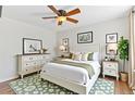 Cozy bedroom with a floral rug, ceiling fan, and a beautifully decorated dresser at 944 E Lily Ct, Highlands Ranch, CO 80126