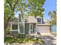 Charming two-story home with a well-manicured lawn, mature trees and a two car garage at 944 E Lily Ct, Highlands Ranch, CO 80126