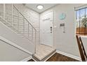 Bright entryway with a staircase, white door, key hooks and updated lighting at 1060 S Parker Rd # 19, Denver, CO 80231