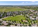 Expansive aerial view showcasing the neighborhood, green spaces, and mountain views at 12427 James Ct, Broomfield, CO 80020