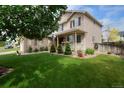 Inviting home exterior with a welcoming porch and lush green lawn at 13441 Cherry St, Thornton, CO 80241