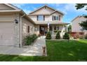 Beautiful two-story home featuring a charming porch, stone accents, and well-kept landscaping at 13441 Cherry St, Thornton, CO 80241