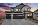 Beautiful two-story home featuring a three-car garage and a covered front porch at 693 Penn Rd, Elizabeth, CO 80107