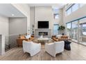 Spacious living room featuring high ceilings, a fireplace, and ample natural light at 48 Newport St, Denver, CO 80230