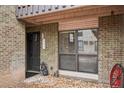 Charming entrance to unit featuring brick facade, decorative window, bear statue and an inviting front door at 3550 S Harlan St # 335, Denver, CO 80235