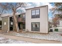 Inviting multi-level condo featuring brick and vinyl siding, complemented by mature trees and a cozy balcony at 3550 S Harlan St # 335, Denver, CO 80235