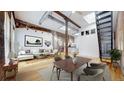 Open living room boasting exposed brick, high ceilings, and modern furnishings at 1510 Wazee St # 3, Denver, CO 80202