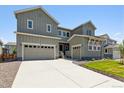 Stunning two-story home featuring a gray exterior, well-maintained lawn, and attached three car garage at 1714 Morgan Dr, Erie, CO 80516
