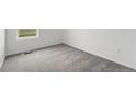 Bedroom showcasing neutral carpet, white walls, and window letting in natural light at 17117 W 91St Ln, Arvada, CO 80007