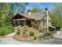 Exterior view of a home with beautiful landscaping, a stone walkway, and a welcoming front porch at 740 Carr St, Lakewood, CO 80214