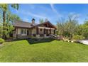 Charming home with a well-maintained lawn, stone porch, and mature trees in a peaceful setting at 740 Carr St, Lakewood, CO 80214