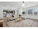Bright living room features a large window, modern lighting, and an adjacent kitchen at 8073 Mt Lincoln Rd, Littleton, CO 80125