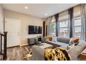 Stylish living room with a large sectional sofa, modern decor, and ample natural light at 1519 S Dayton St, Denver, CO 80247