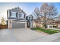 Traditional two-story home with a wide driveway and a basketball hoop for outdoor fun at 9505 Painted Canyon Cir, Highlands Ranch, CO 80129