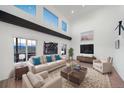 Airy living room with high ceilings, modern furnishings, and large windows showcasing mountain views at 9505 Painted Canyon Cir, Highlands Ranch, CO 80129