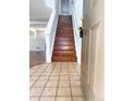 Inviting entryway featuring tile flooring transitioning to hardwood stairs and an open view of the living spaces at 20401 E Chenango Pl, Aurora, CO 80015