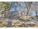 Side view of a well-maintained home featuring classic architecture and mature trees enhancing its curb appeal at 624 S Depew St # C, Lakewood, CO 80226