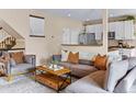 Cozy living room with comfortable seating, a stylish coffee table, and an open connection to the kitchen at 6813 W Yale Ave, Lakewood, CO 80227