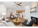 Inviting living area featuring a ceiling fan, fireplace, and open access to the kitchen at 8251 W 54Th Ave # 4, Arvada, CO 80002