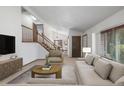 Inviting living room featuring stylish furnishings, a staircase, and neutral decor at 18083 E Atlantic Dr, Aurora, CO 80013