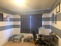 Bedroom showcasing neutral carpet and gray and white striped accent wall at 23465 E Platte Dr # C, Aurora, CO 80016