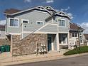 Side exterior view of townhome featuring blue siding and convenient gas meter access at 23465 E Platte Dr # C, Aurora, CO 80016