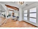 Inviting entryway with hardwood floors, a modern light fixture, and an open view to the living spaces at 6220 E 5Th Ave, Denver, CO 80220