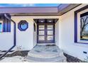 Modern front entrance featuring a stylish double door with glass inserts and decorative accent window at 6220 E 5Th Ave, Denver, CO 80220