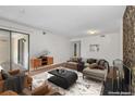 Cozy living room with fireplace and sliding glass doors to a patio area at 3662 S Granby Way # J05, Aurora, CO 80014