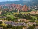 Panoramic view of Arrowhead Golf Club, scenic rock formations, and residential community at 6338 Spotted Fawn Run, Littleton, CO 80125