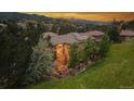 Aerial view of backyard patio with firepit, and two story windows with views of the mountains at 6338 Spotted Fawn Run, Littleton, CO 80125