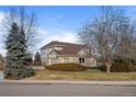 A well-maintained home, showcasing a manicured lawn and mature landscaping in a quiet, friendly neighborhood at 7202 Snow Peak Ct, Niwot, CO 80503