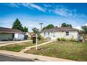 Cozy single-story home with a well-kept lawn and a 'For Sale' sign in the yard at 3125 W Ford Pl, Denver, CO 80219