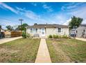 Single-story home with a sidewalk, complemented by tidy landscaping and a cozy bench at 3125 W Ford Pl, Denver, CO 80219