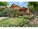 Charming two-story home featuring vibrant yellow siding, red trim, mature landscaping, and a quaint front porch at 3201 W 126Th Ave, Broomfield, CO 80020