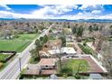 An aerial view that showcases the home's setting within a tranquil neighborhood and close proximity to a green park at 100 Balsam St, Lakewood, CO 80226