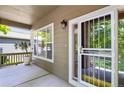 Covered front porch area with secure ornamental door and a decorative potted plant at 5755 W Berry Ave, Denver, CO 80123