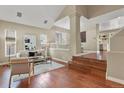 Bright living room featuring hardwood floors, large windows, and contemporary decor at 5755 W Berry Ave, Denver, CO 80123