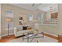 Cozy living room with hardwood floors, bright windows, and neutral-toned contemporary decor at 5755 W Berry Ave, Denver, CO 80123