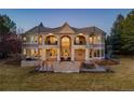 Elegant home with a covered patio, outdoor dining, and lush lawn, perfect for entertaining guests at 73 Glenmoor Dr, Cherry Hills Village, CO 80113