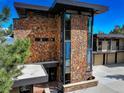 Close-up of the stone exterior of a luxurious home with modern windows and unique architectural details at 180 Outpost Ln, Evergreen, CO 80439