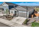 Beautiful shot of the home and its yard with new landscaping and a driveway at 476 Silver Rock Trl, Castle Rock, CO 80104